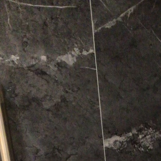 Close detail of charcoal marble-look shower tile